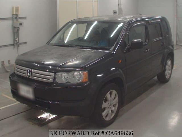 A grey JDM sports car speeding down a highway at night.