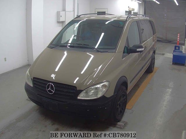 A grey JDM sports car speeding down a highway at night.