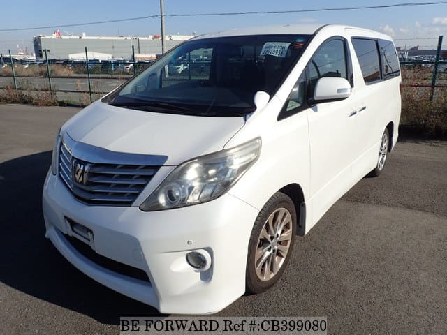 A grey JDM sports car speeding down a highway at night.