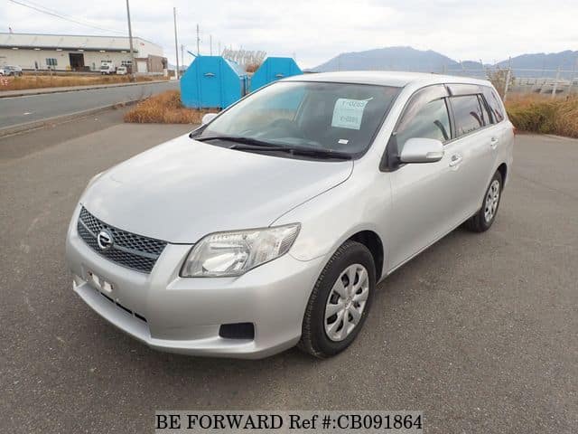 A grey JDM sports car speeding down a highway at night.