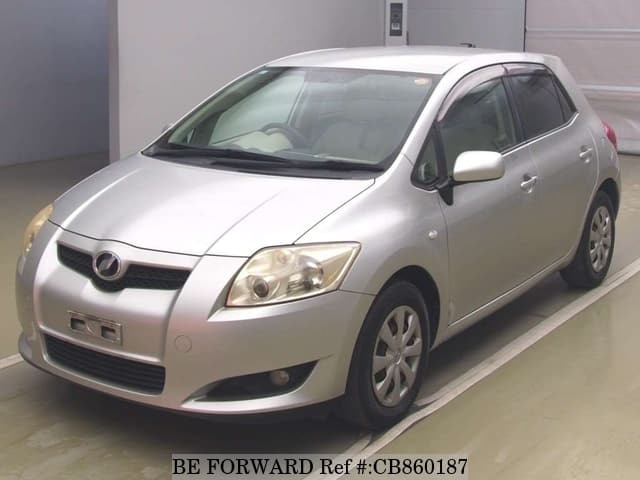 A grey JDM sports car speeding down a highway at night.