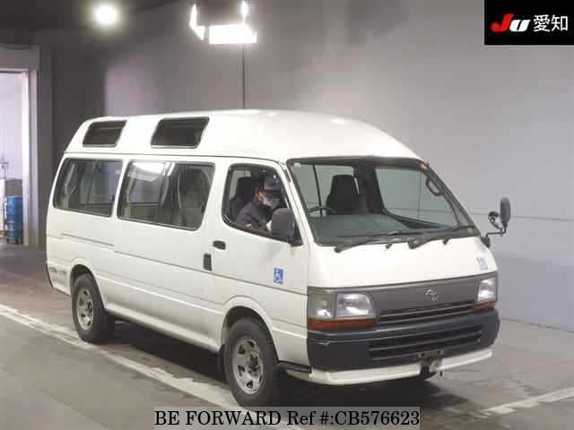 A grey JDM sports car speeding down a highway at night.