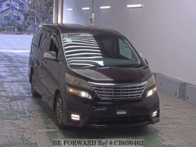 A grey JDM sports car speeding down a highway at night.