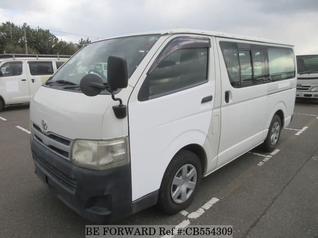 A grey JDM sports car speeding down a highway at night.