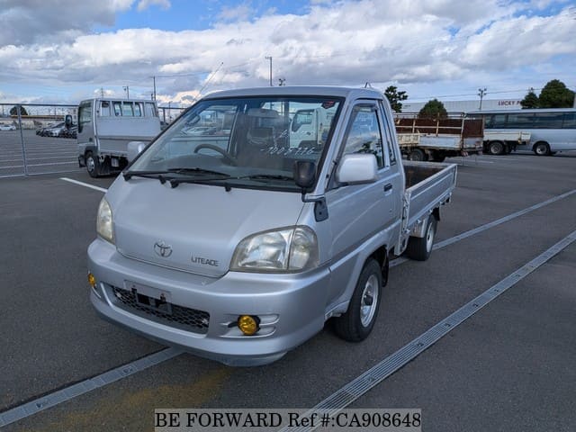 A grey JDM sports car speeding down a highway at night.