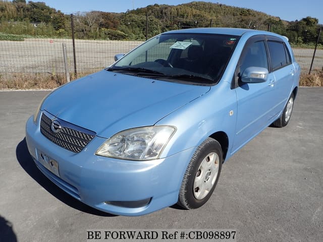 A grey JDM sports car speeding down a highway at night.