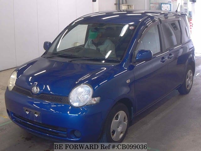 A grey JDM sports car speeding down a highway at night.