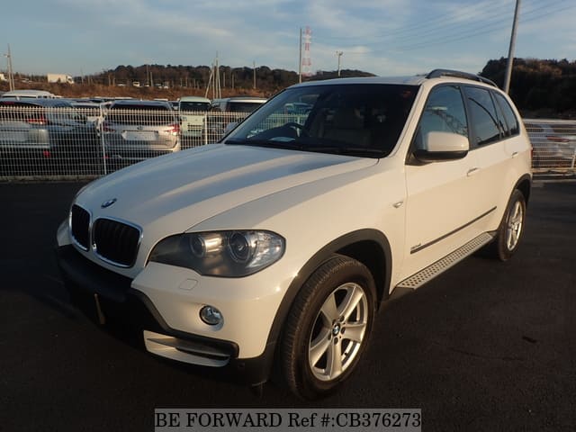 A grey JDM sports car speeding down a highway at night.