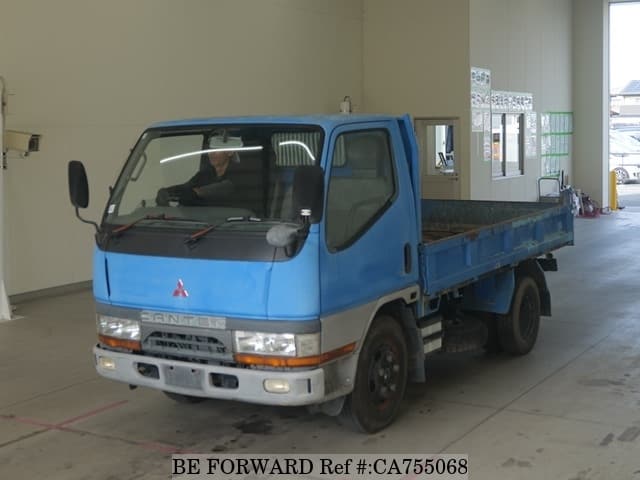 A grey JDM sports car speeding down a highway at night.