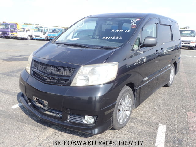 A grey JDM sports car speeding down a highway at night.