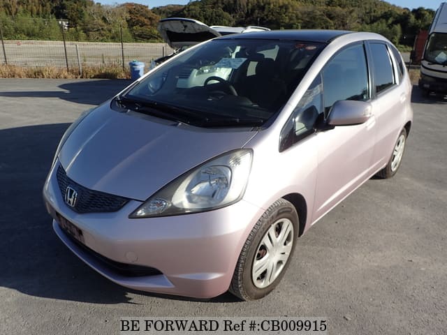 A grey JDM sports car speeding down a highway at night.