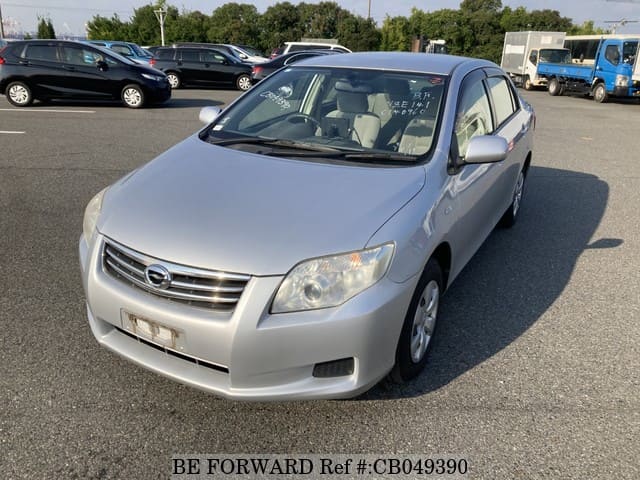 A grey JDM sports car speeding down a highway at night.