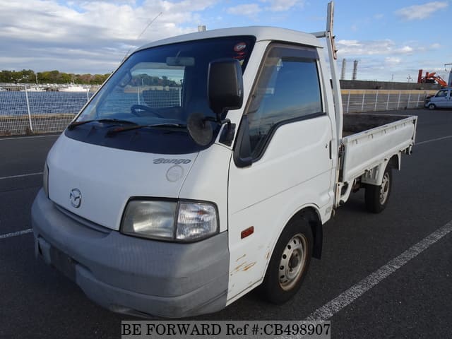 A grey JDM sports car speeding down a highway at night.