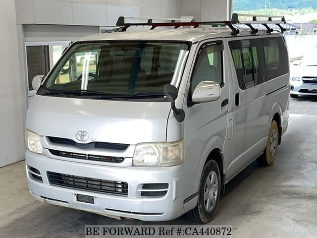 A grey JDM sports car speeding down a highway at night.