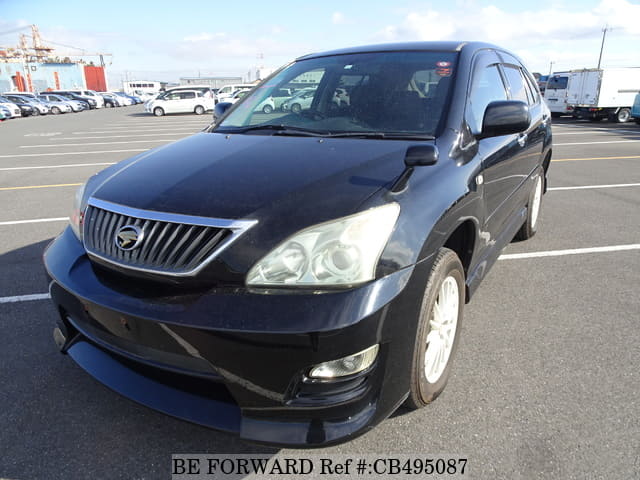 A grey JDM sports car speeding down a highway at night.