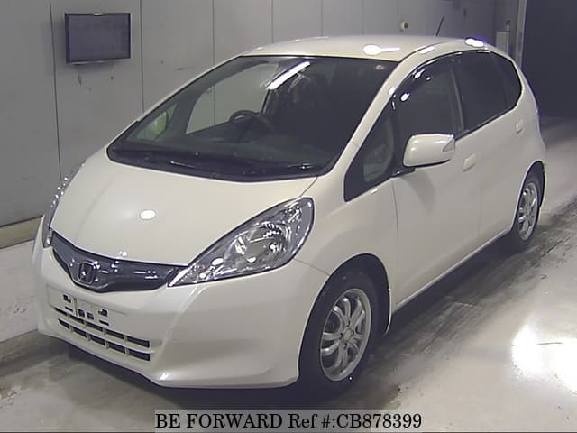 A grey JDM sports car speeding down a highway at night.