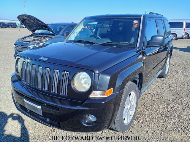 A grey JDM sports car speeding down a highway at night.