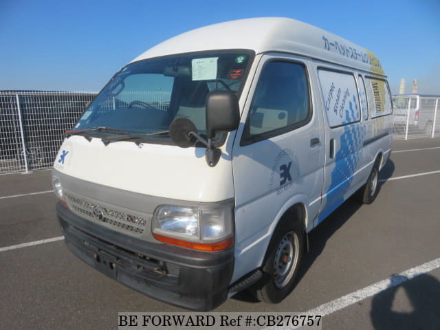 A grey JDM sports car speeding down a highway at night.