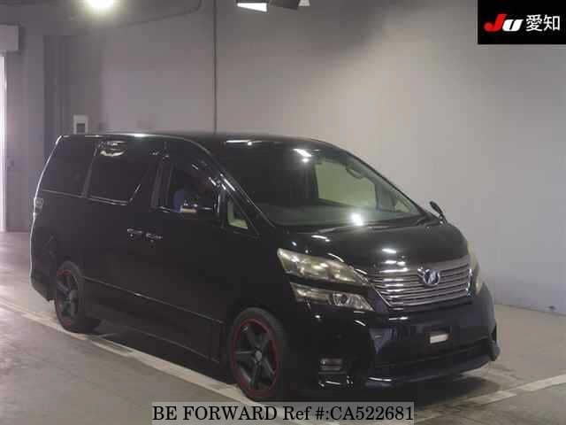 A grey JDM sports car speeding down a highway at night.