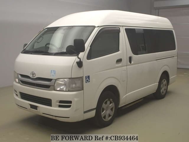 A grey sports car speeding down a highway at night.