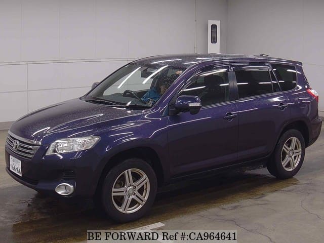 A grey JDM sports car speeding down a highway at night.