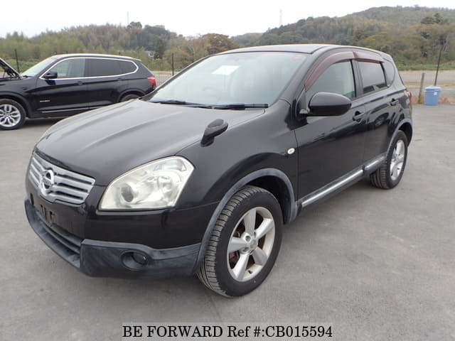 A grey JDM sports car speeding down a highway at night.