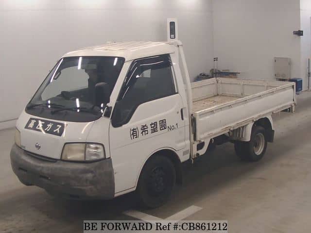 A grey JDM sports car speeding down a highway at night.
