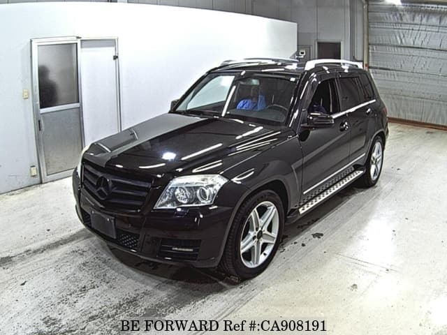 A grey JDM sports car speeding down a highway at night.