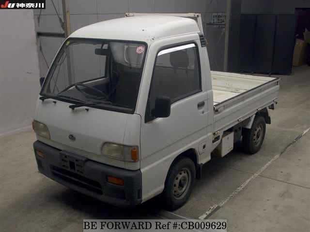 A grey JDM sports car speeding down a highway at night.