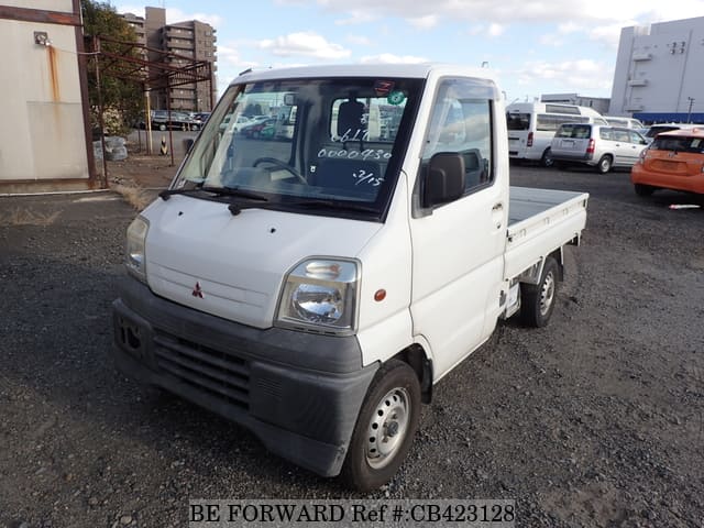 A grey JDM sports car speeding down a highway at night.