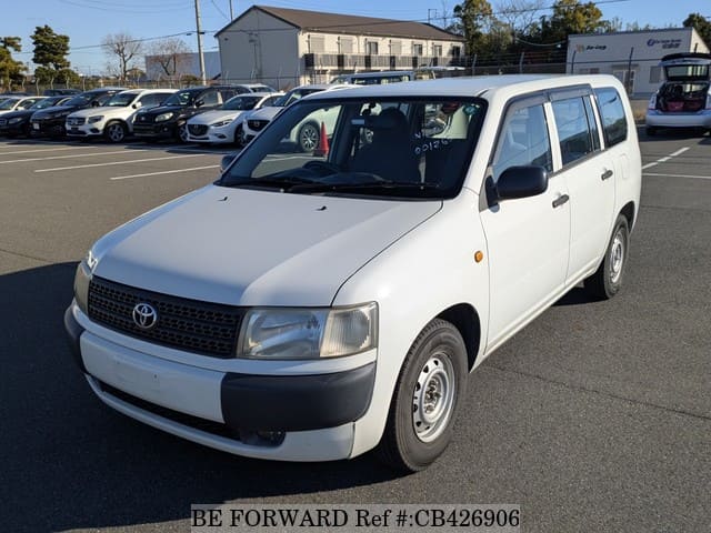 A grey JDM sports car speeding down a highway at night.
