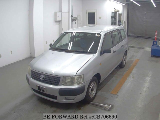 A grey JDM sports car speeding down a highway at night.