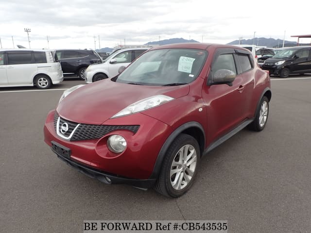 A grey JDM sports car speeding down a highway at night.