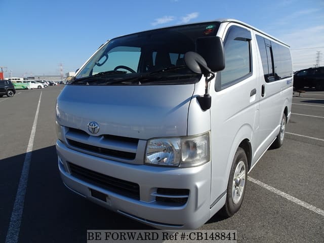 A grey JDM sports car speeding down a highway at night.