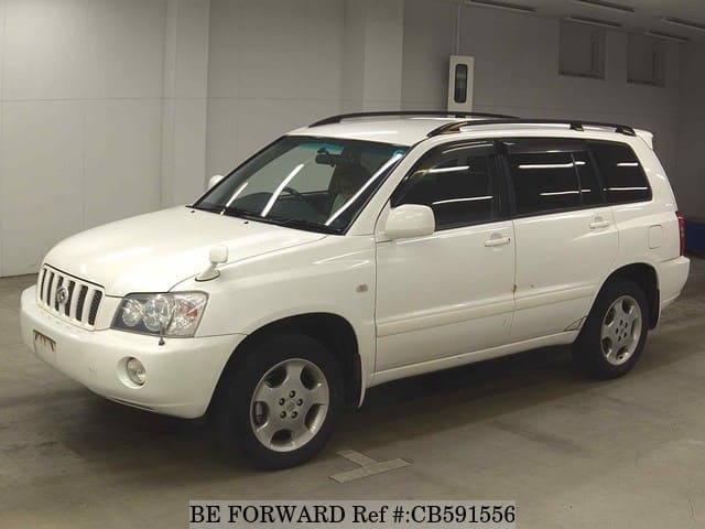 A grey JDM sports car speeding down a highway at night.