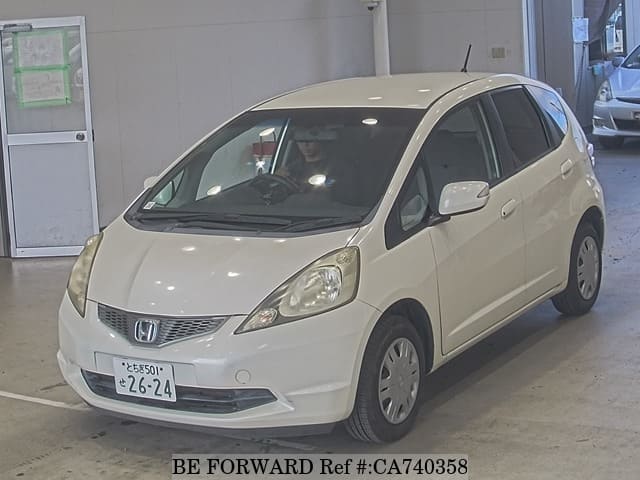 A grey JDM sports car speeding down a highway at night.