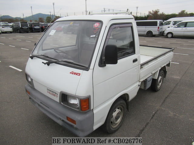 A grey JDM sports car speeding down a highway at night.