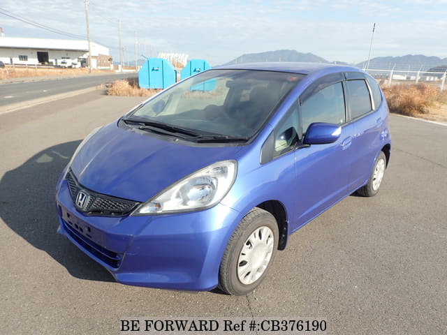 A grey JDM sports car speeding down a highway at night.