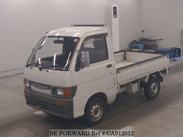 A grey JDM sports car speeding down a highway at night.