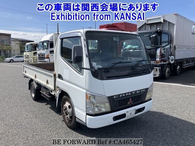 A grey JDM sports car speeding down a highway at night.