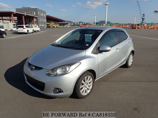 A grey JDM sports car speeding down a highway at night.