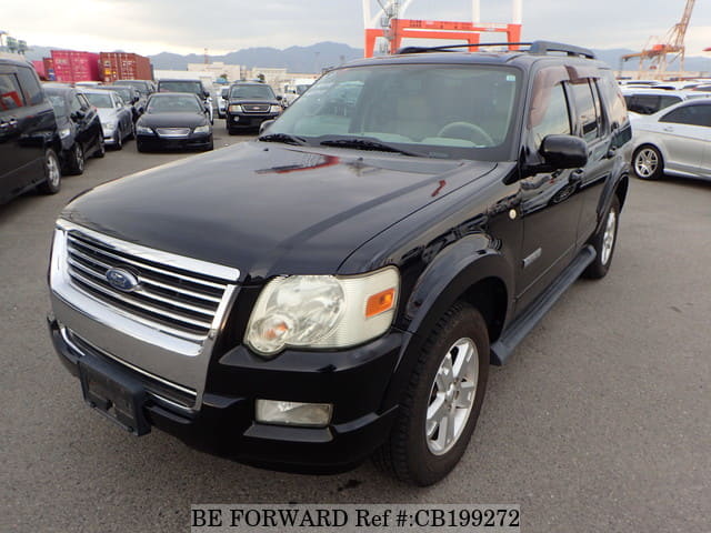 A grey JDM sports car speeding down a highway at night.