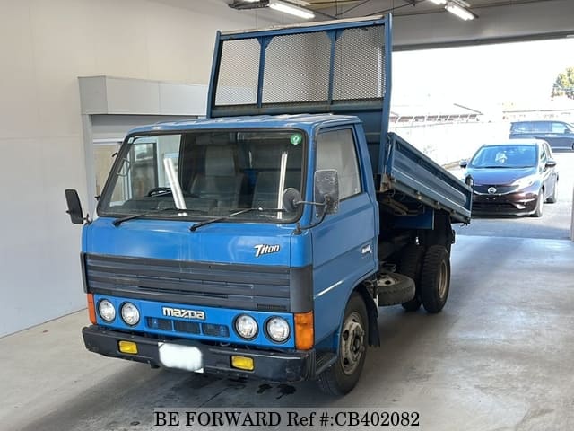 A grey JDM sports car speeding down a highway at night.