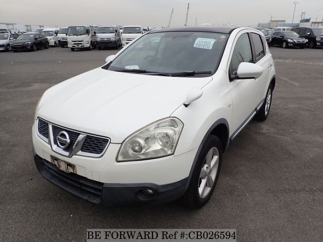A grey JDM sports car speeding down a highway at night.
