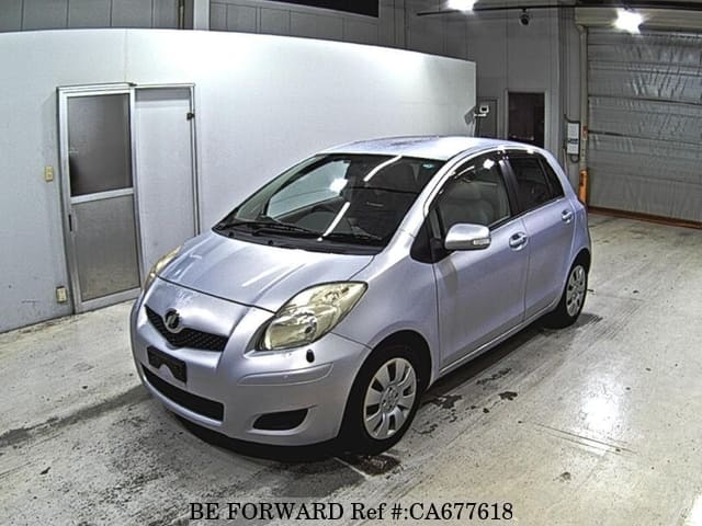 A grey JDM sports car speeding down a highway at night.