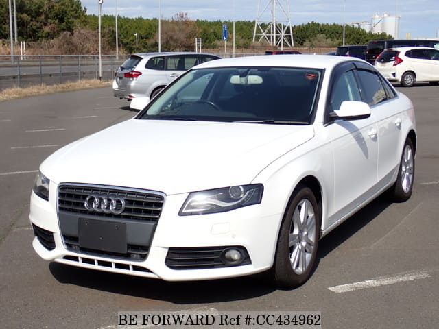 A grey JDM sports car speeding down a highway at night.