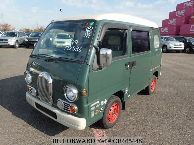 A grey JDM sports car speeding down a highway at night.