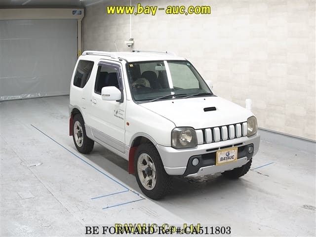 A grey JDM sports car speeding down a highway at night.