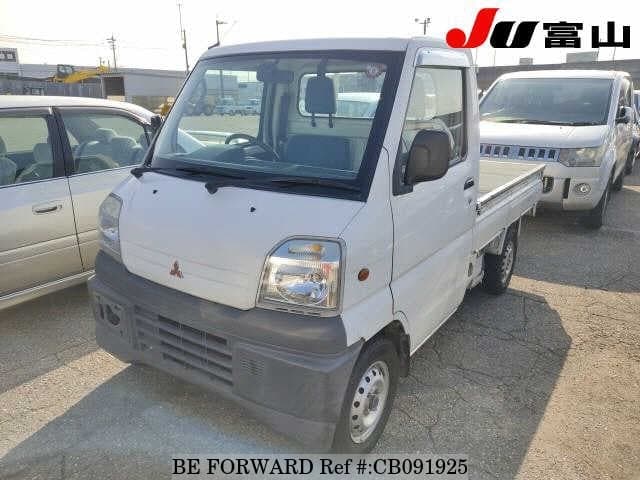 A grey JDM sports car speeding down a highway at night.