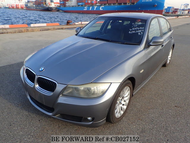 A grey JDM sports car speeding down a highway at night.